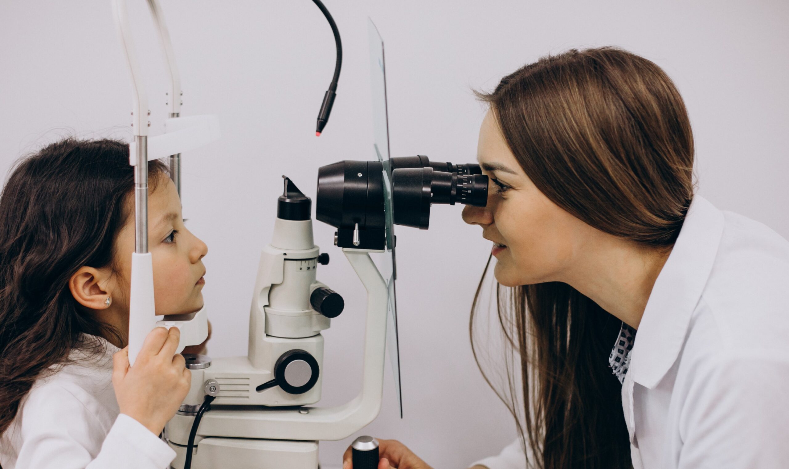 little girl checking up her sight ophthalmology center scaled